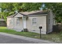 Single-story home with a covered entry, neat landscaping, and mailbox at 603 Paradise St, Monroe, NC 28112
