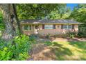 Lovely brick home with charming details, including decorative window accents and a cozy front entrance at 6632 Candlewood Dr, Charlotte, NC 28210