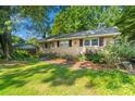 Beautiful brick home featuring manicured landscaping, walkway and lush greenery, adding to its appeal at 6632 Candlewood Dr, Charlotte, NC 28210