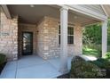 Close-up of the welcoming front porch with a stone facade and a view of the front door at 860 Wynnshire Dr, Hickory, NC 28601
