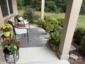 Charming front porch with chairs, plants, and neutral rug at 860 Wynnshire Dr, Hickory, NC 28601