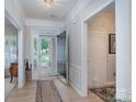 Welcoming foyer features an open front door, light wood floors, and detailed trim work at 8637 Annabel Lee Ln, Charlotte, NC 28277