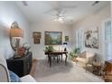 Bright home office with decorative paintings, comfortable seating, and natural light from windows at 8637 Annabel Lee Ln, Charlotte, NC 28277