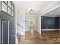 Welcoming foyer with hardwood floors, staircase, and elegant light fixture at 1008 Dumbarton Rd, Gastonia, NC 28054