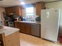 Functional kitchen design featuring modern appliances, wood cabinets, and ample counter space at 1064 Calico Farm Ct, Cleveland, NC 27013