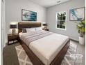Modern bedroom with a large window, neutral color palette, and stylish decor at 11103 Fox Cove Dr, Charlotte, NC 28273