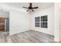 Bright dining room featuring a ceiling fan, large window, modern floors, and fresh, neutral paint at 11411 Ridge Oak Dr, Charlotte, NC 28273