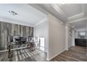 Inviting home office space with a modern glass desk and wood-look accent wall at 1169 Hollis Sw Cir, Concord, NC 28025