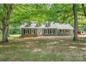 Inviting home featuring mature trees, providing ample shade and enhancing its curb appeal at 133 Pecan Ln, Salisbury, NC 28146
