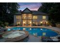 A backyard oasis features a sparkling pool, spa, and an open porch perfect for entertaining at 146 Bullfinch Rd, Mooresville, NC 28117