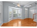Sunlit room with wood floors, a ceiling fan and large windows at 157 Talbert Town Loop, Mooresville, NC 28117
