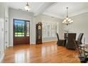 Elegant dining room featuring wood floors, chandelier, and natural light with backyard view at 170 Saint James Way, Salisbury, NC 28147