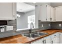 Close-up of kitchen sink, wood countertops, and modern fixtures at 1706 Baylor Dr, Rock Hill, SC 29732