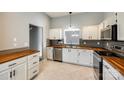 Stylish kitchen with stainless appliances, wood countertops, tile floors, and a gray backsplash at 1706 Baylor Dr, Rock Hill, SC 29732