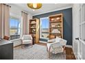 Stylish home office featuring built-in bookshelves, a comfortable rug, and ample natural light at 2005 Waxhaw Crossing Dr # 241, Waxhaw, NC 28173