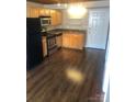A well-lit kitchen with stainless steel appliances and wooden cabinets at 201 S Hoskins Rd # 328, Charlotte, NC 28208