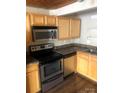Stainless steel appliances and wood cabinets add a modern touch to the kitchen at 201 S Hoskins Rd # 328, Charlotte, NC 28208