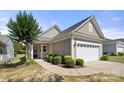 Charming single-story home with a well-manicured lawn and attached two car garage at 20241 Dovekie Ln, Indian Land, SC 29707