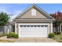 Attached two car garage with white door and low maintenance landscaping at 20241 Dovekie Ln, Indian Land, SC 29707