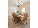 Bright dining room featuring a wood table, chairs, and a chandelier, with a view into another room at 275 Dorothy Dr, China Grove, NC 28023