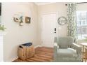 Cozy corner in living room with comfortable armchair, woven basket, and a stylish mirror at 342 Battery Cir, Clover, SC 29710
