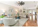 Bright living room with hardwood floors, neutral-toned couches, and a ceiling fan at 342 Battery Cir, Clover, SC 29710