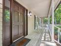 Close-up of the front door with sidelights, rocking chairs, and a well-maintained porch at 3701 Bounty Ct, Matthews, NC 28104