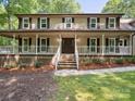 Inviting front porch with white railings, rocking chairs, and a classic entrance at 3701 Bounty Ct, Matthews, NC 28104