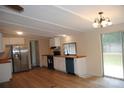 Bright kitchen features white cabinets, stainless steel appliances, wood countertops, hardwood style floors, and sliding door access at 561 Woodglenn Rd, Catawba, SC 29704