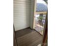 A cozy outdoor balcony featuring wood flooring and a view of surrounding greenery at 6260 Rosecroft Dr, Charlotte, NC 28215