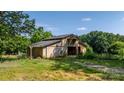 A rustic barn provides ample storage or workshop space, set amidst a backdrop of mature trees at 6314 Providence Church Rd, Vale, NC 28168