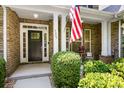 Inviting front porch with a patriotic display, stylish door, and well-maintained landscaping at 7327 Snowbird Ct, Mint Hill, NC 28227