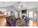 Spacious living room with vaulted ceiling, hardwood floors, a fireplace, and ample natural light creates an inviting atmosphere at 773 Hathcock Glen Dr, Oakboro, NC 28129