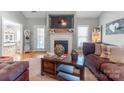Cozy living room features a fireplace, a mantel with decor, and hardwood floors, perfect for relaxing evenings at 773 Hathcock Glen Dr, Oakboro, NC 28129