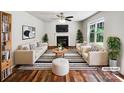 Bright living room featuring a fireplace, hardwood floors and neutral furniture arrangement at 8701 Holly Creek Ct, Charlotte, NC 28216