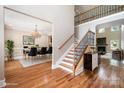 Elegant entryway boasting hardwood floors, staircase with iron railings, and views into the dining and living areas at 101 Mcalway Rd, Charlotte, NC 28211