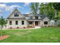 Beautiful two-story home featuring a manicured lawn, complemented by a stylish brick facade and a welcoming entryway at 101 Mcalway Rd, Charlotte, NC 28211