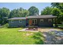 Charming single-story home with a well-maintained lawn, inviting walkway, and quaint front porch at 108 Graham St, Stanley, NC 28164