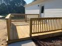 Close-up of a newly built wooden deck with a railing, perfect for outdoor relaxation at 1103 Adams St, Statesville, NC 28677