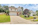 Inviting two-story home with a well-maintained lawn, spacious driveway, and a cozy front porch at 1288 Century Dr, Clover, SC 29710