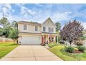 Charming two-story home featuring a manicured lawn, inviting front porch, and a driveway at 1288 Century Dr, Clover, SC 29710