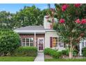 Attractive townhouse exterior featuring brick detail and a crape myrtle tree with red blossoms at 12914 Sickles Dr, Charlotte, NC 28273