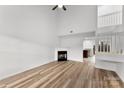 Bright, modern living room featuring a fireplace, ceiling fan, and beautiful light wood floors at 12914 Sickles Dr, Charlotte, NC 28273