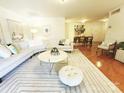 Spacious living room with a curved sofa, area rug, and an open floor plan at 1323 Queens Rd # 327, Charlotte, NC 28207