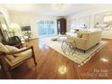 Inviting living room with hardwood flooring, stylish furniture, and a sliding door to the outside at 1323 Queens Rd # 327, Charlotte, NC 28207