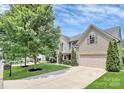 Traditional two-story home with landscaped front yard and long driveway leading to attached garage at 1427 Rosemont Dr, Indian Land, SC 29707