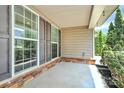 Covered porch featuring brick accents, siding, and windows with dark shutters at 1427 Rosemont Dr, Indian Land, SC 29707