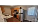 Well-equipped kitchen with stainless steel appliances, granite countertops and wood cabinets at 165 Brantley Place Dr, Mooresville, NC 28117