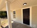 Close-up of the black front door and porch of a charming home at 179 Duval Nw St, Concord, NC 28025