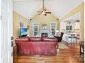 Inviting living room featuring a fireplace, vaulted ceiling, and wood floors at 1842 Caroline Way, Fort Mill, SC 29715